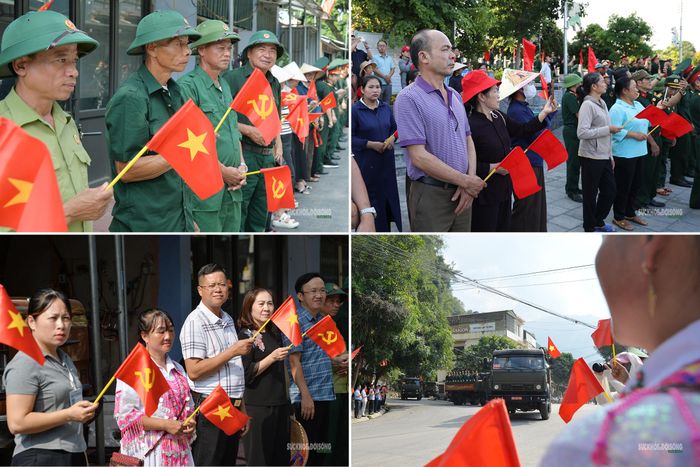 Người dân lặng lẽ dõi theo đoàn xe dẫn đầu mang vòng hoa tưởng niệm các liệt sĩ. Ảnh: Tuấn Anh