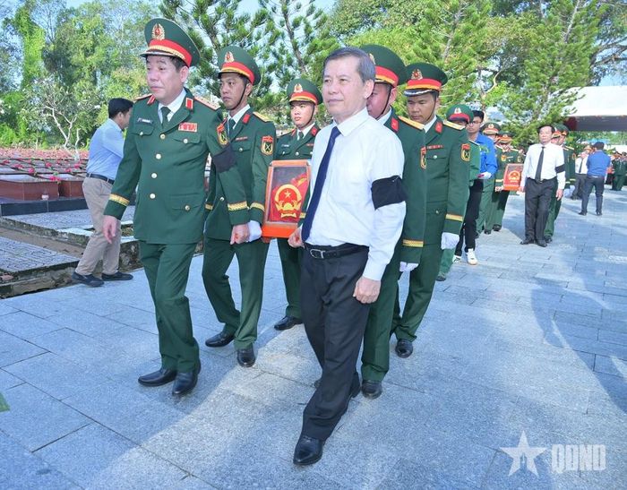 Đồng chí Lê Minh Trí và Thượng tướng Nguyễn Văn Gấu cùng các đại biểu thực hiện nghi thức an táng hài cốt liệt sĩ. 