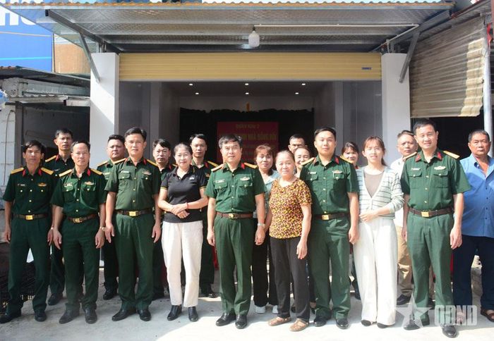 Đại tá Trần Đức Sinh và chỉ huy Kho K79 cùng nhân dân tổ dân phố 4, phường Mường Thanh, tỉnh Điện Biên chụp ảnh cùng gia đình Thượng úy QNCN Nguyễn Hải long trong Lễ khánh thành, bàn giao nhà.