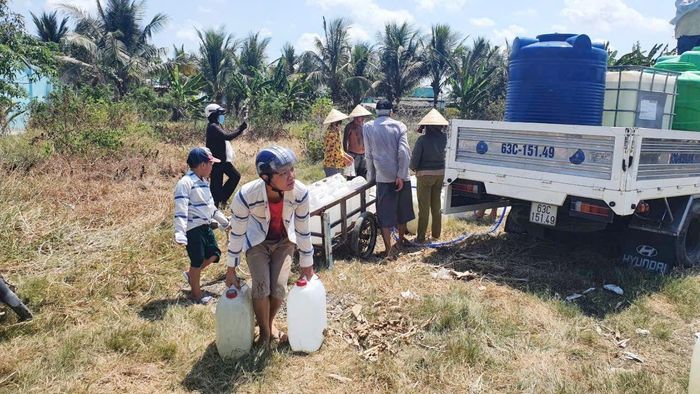  Người dân khu vực Gò Công Đông (tỉnh Đồng Tháp) nhận nước ngọt sinh hoạt trong mùa khô từ một ﻿đơn vị tài trợ. Ảnh: NGỌC PHÚC 