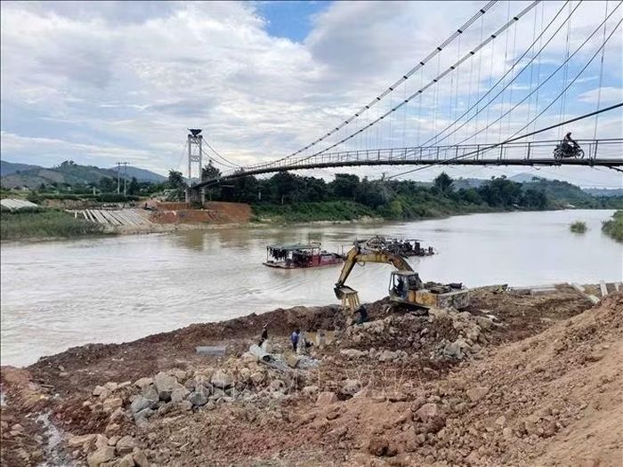 Khu vực mố chân cầu Đức Xuyên đang được nỗ lực gia cố nhằm đảm bảo việc đi lại của người dân. Ảnh: Kha Phạm/TTXVN