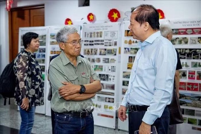 Các nhà nghiên cứu trao đổi về những kết quả khảo cổ học được giới thiệu tại không gian trưng bày bên lề Hội thảo. Ảnh: Phạm Tuấn Anh/TTXVN
