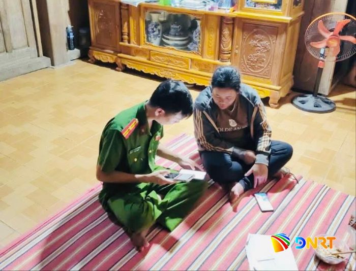 Công an xã Tây Giang xuống tận nhà dân, hướng dẫn người dân thao tác trên thiết bị điện tử để thực hiện thủ tục hành chính trực tuyến. Ảnh: ĐVCC