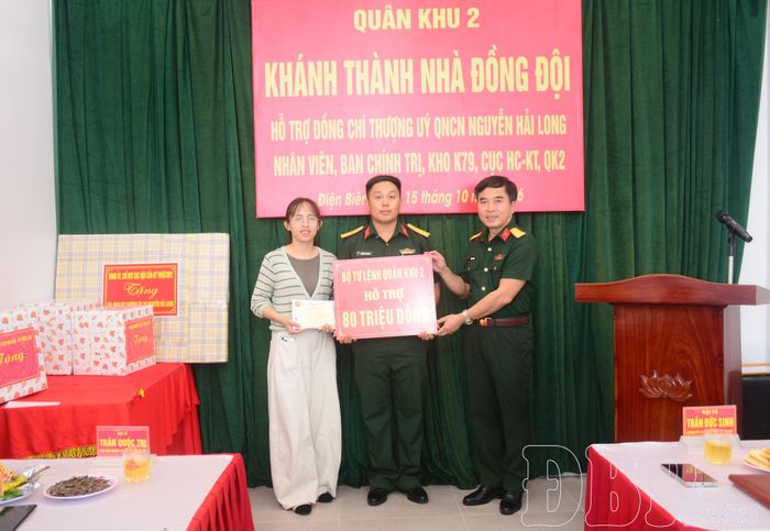 Đại tá Trần Đức Sinh trao biểu trưng số tiền hỗ trợ gia đình Thượng úy QNCN Nguyễn Hải Long.
