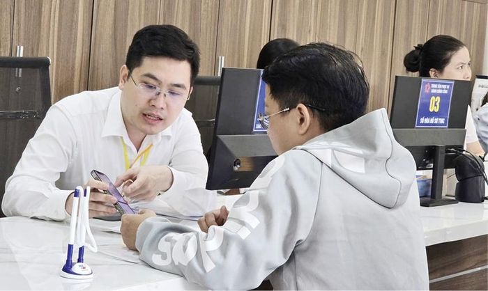 Cán bộ Trung tâm Phục vụ hành chính công Phú Xuân hỗ trợ người dân khi đến giao dịch.