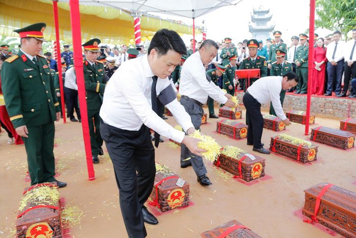 Các đại biểu thực hiện nghi thức tiễn đưa, an táng hài cốt liệt sĩ và đồng bào tử nạn.(Ảnh do Báo và phát thanh, truyền hình Hải Phòng cung cấp)