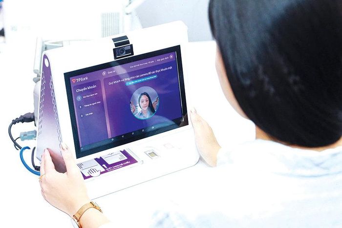 Khách hàng giao dịch bằng sinh trắc học, chữ ký số tại TPBank chi nhánh Hà Nội. Ảnh: Phạm Hùng