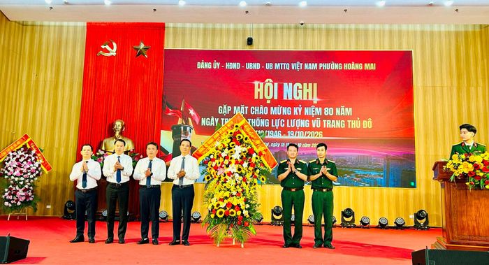Lãnh đạo phường Hoàng Mai tặng hoa chúc mừng Ban Chỉ huy quân sự phường. Ảnh: Trần Oanh