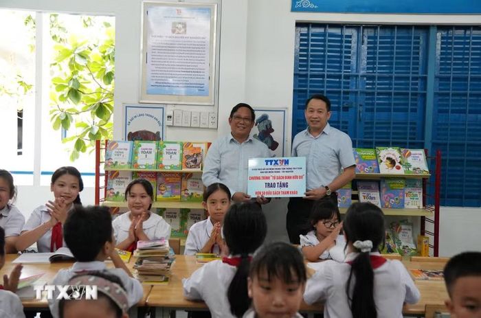 Ông Nguyễn Việt Dũng, Bí thư Đảng ủy, Giám đốc Trung tâm Thông tin TTXVN khu vực miền Trung-Tây Nguyên và Hiệu trưởng trường Tiểu học Tây Nha Trang bên tủ sách Đinh Hữu Dư trong thư viện của trường. (Ảnh: Nguyễn Dũng/TTXVN)