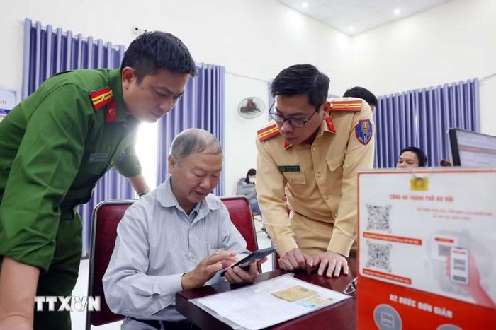 (Tư liệu) Cảnh sát giao thông Hà Nội tuyên truyền, hướng dẫn người dân thực hiện làm sạch dữ liệu đăng ký phương tiện, giấy phép lái xe. (Ảnh: Phạm Kiên/TTXVN)