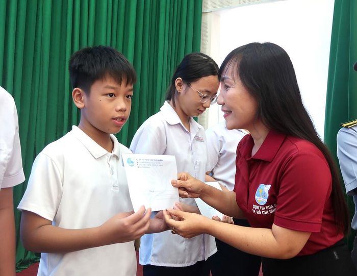 Chị Trịnh Thị Thanh tặng quà cho các em tại chương trình “Ấm tình hậu phương - Vững lòng lính biển”.