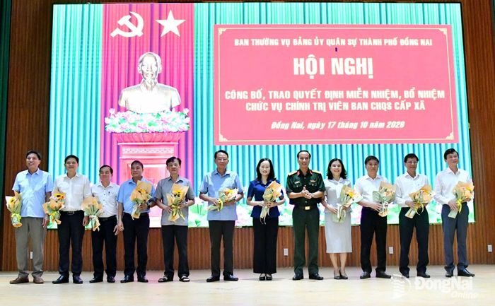 Đại tá Võ Thành Danh tặng hoa cảm ơn các đồng chí Bí thư Đảng ủy cấp xã đã tham gia giữ cương vị Chính trị viên Ban Chỉ huy Quân sự cấp xã thời gian qua. Ảnh: Minh Tiến