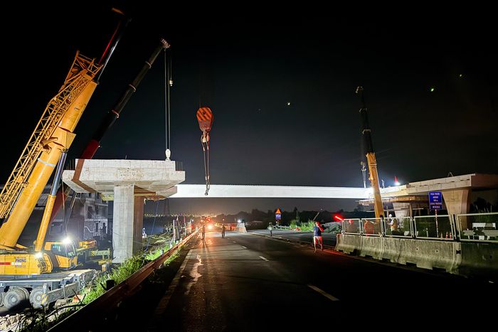 Hơn 00h ngày 17/10, dầm cầu thứ nhất đã hoàn tất lắp đặt, các kỹ sư, công nhân tiếp tục triển khai công đoạn nâng dầm thứ hai.