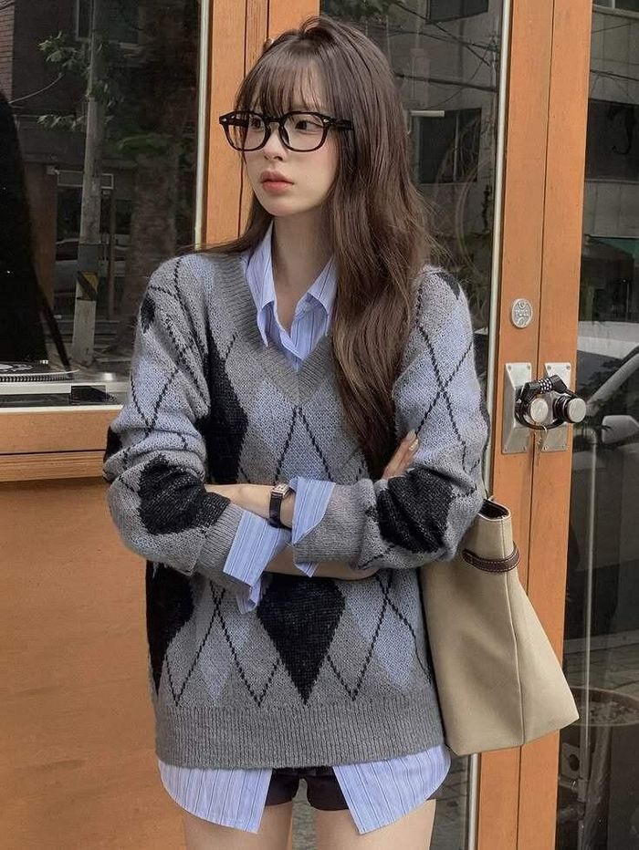 Lớp sơ mi trắng thấp thoáng dưới cổ áo len gợi tinh thần học đường đặc trưng của phong cách preppy. Cách phối này phù hợp với những ngày cần làm mới diện mạo mà không phải sắm thêm nhiều món đồ.
