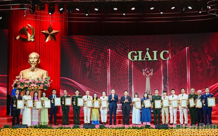 Giám đốc Học viện Chính trị Quốc gia Hồ Chí Minh Đoàn Minh Huấn và Chủ tịch Hội đồng Lý luận Trung ương Nguyễn Xuân Thắng trao giải C cho các tác giả, nhóm tác giả. (Ảnh: DUY LINH)