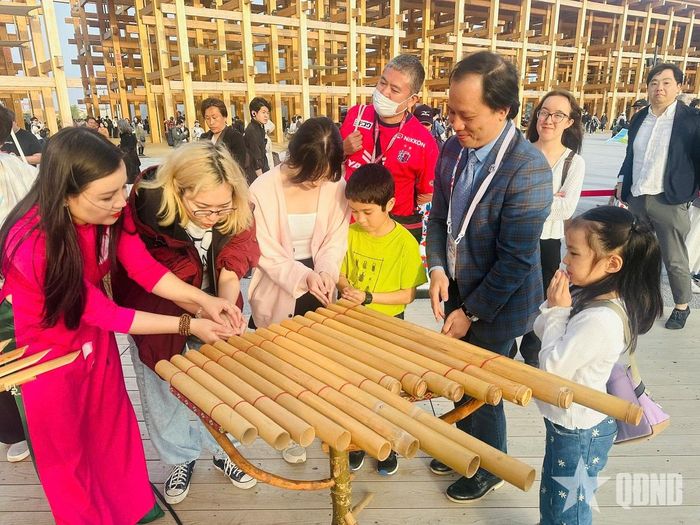 Công chúng trải nghiệm đàn K'lông Pút của đồng bào Tây Nguyên tại Triển lãm thế giới EXPO ở Osaka, Nhật Bản, năm 2025. Ảnh: PHƯƠNG MAI 