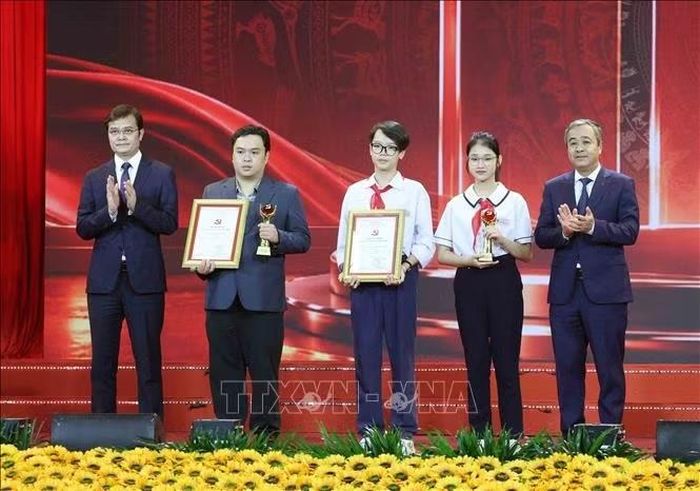 Đại diện tác giả lớn tuổi và nhỏ tuổi nhất nhận Giấy chứng nhận Cuộc thi. Ảnh: Phương Hoa/TTXVN