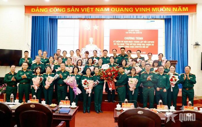 Thủ trưởng Cục Khoa học quân sự tặng hoa chúc mừng cán bộ, hội viên Hội Phụ nữ Cục Khoa học quân sự. 