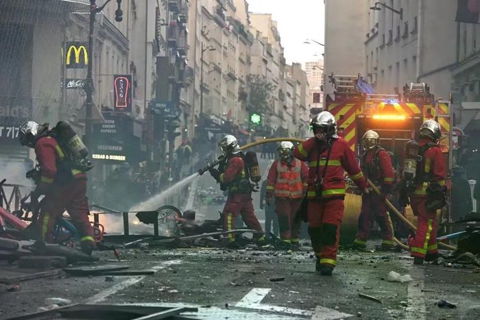 Lính cứu hoả dập tắt đám cháy sau một cuộc biểu tình tại Paris.