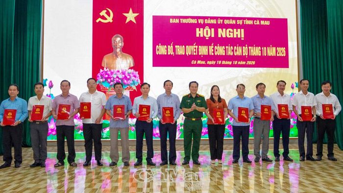 Đại tá Lê Quang Luật (ảnh trên) và Đại tá Trần Quốc Dẹn, Phó Chính uỷ Bộ CHQS tỉnh, trao quyết định cho các đồng chí Bí thư Đảng uỷ xã, phường.