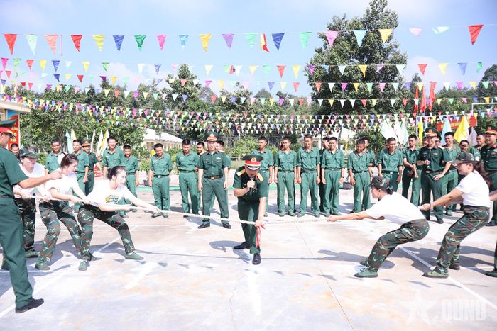 Cán bộ, chiến sĩ và hội viên phụ nữ sôi nổi tham gia trò chơi kéo co, tạo không khí vui tươi, đoàn kết trong chuỗi hoạt động chào mừng Ngày Phụ nữ Việt Nam. 