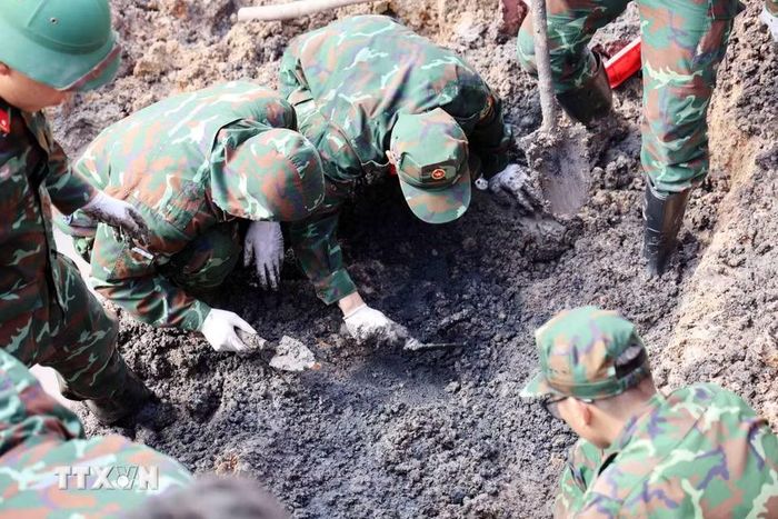 Cán bộ, chiến sỹ đội K74 đẩy mạnh tiến độ tìm kiếm, quy tập hài cốt liệt sỹ tại công viên Lê Thị Riêng. (Ảnh: Xuân Khu/TTXVN)