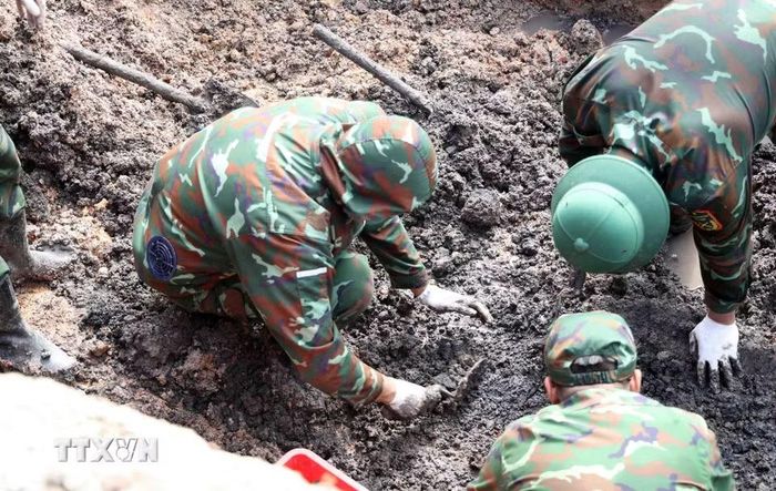 Cán bộ, chiến sỹ đội K74 đẩy mạnh tiến độ tìm kiếm, quy tập hài cốt liệt sỹ tại công viên Lê Thị Riêng. (Ảnh: Xuân Khu/TTXVN)