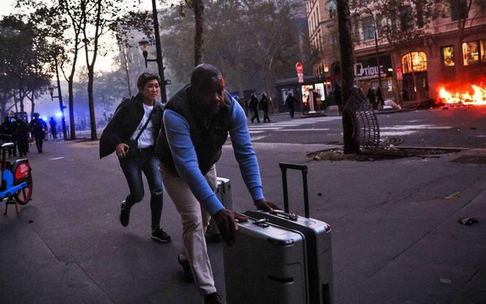 Khách du lo ngại khi di chuyển, giữa lúc làn sóng biểu tình gây náo loạn tại Paris cuối tuần qua. Ảnh: Kiran Ridley/AFP