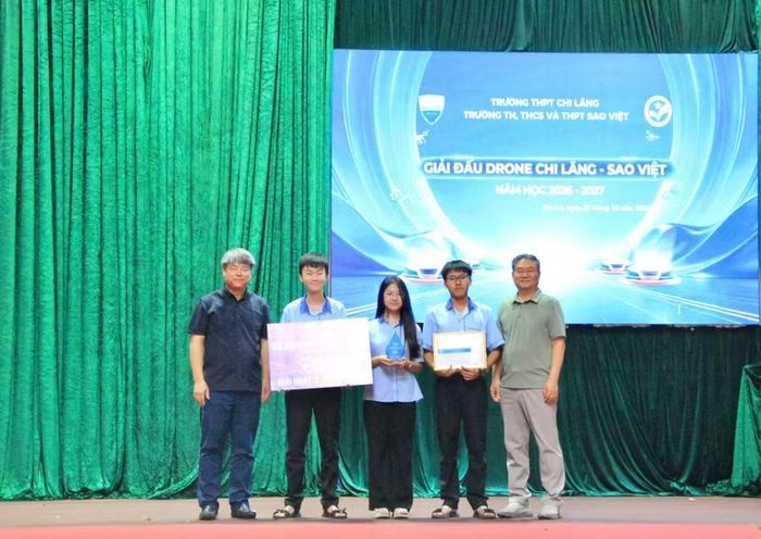  Sau những ngày tháng miệt mài nghiên cứu và thực hành, những chiếc cúp danh giá đã có chủ. Hai cố vấn giáo dục đại diện Ban tổ chức trao giải cho các đội đạt thành tích tại Giải đấu Drone Chi Lăng - Sao Việt năm học 2026-2027, ghi nhận nỗ lực thực hành, vận dụng kiến thức và khả năng làm chủ công nghệ của học sinh. Ảnh: Hoàng Hoài 