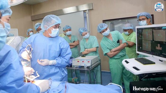 Các chuyên gia và bác sĩ triển khai phẫu thuật ứng dụng robot điều trị bệnh lý cột sống cho bệnh nhân tại BVTW Huế.