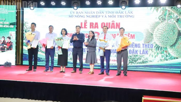 Lãnh đạo Trung tâm Khuyến nông quốc gia và Sở Nông nghiệp và Môi trường tỉnh Đắk Lắk tặng hoa chúc mừng các đơn vị tham gia thực hiện chiến dịch. (Ảnh: CÔNG LÝ)