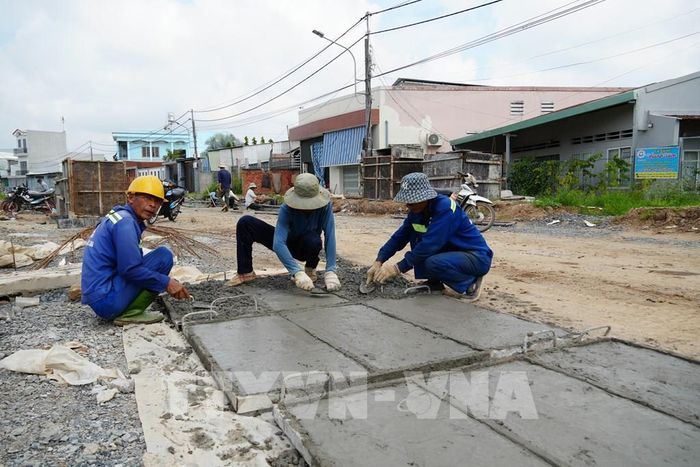 Thi công phân đoạn 4 dự án Đường giao thông hai bên bờ sông Bảo Định. Ảnh: Công Trí - TTXVN