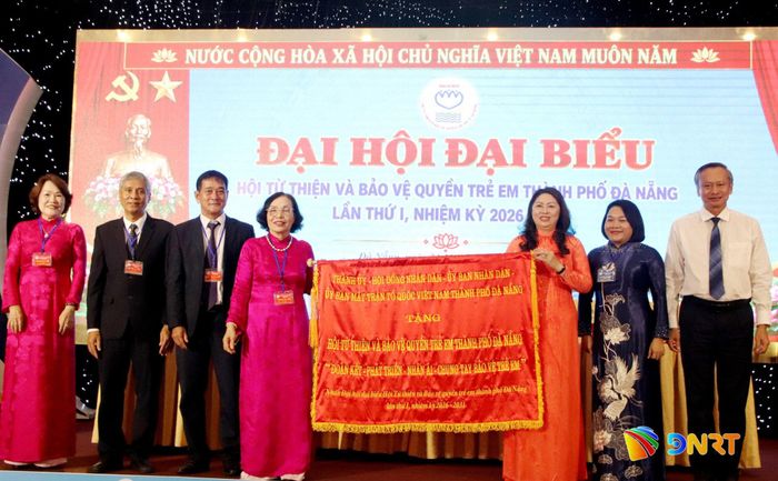 Lãnh đạo thành phố trao tặng bức trướng cho Hội Từ thiện và Bảo vệ quyền trẻ em thành phố. Ảnh: TRỌNG HUY