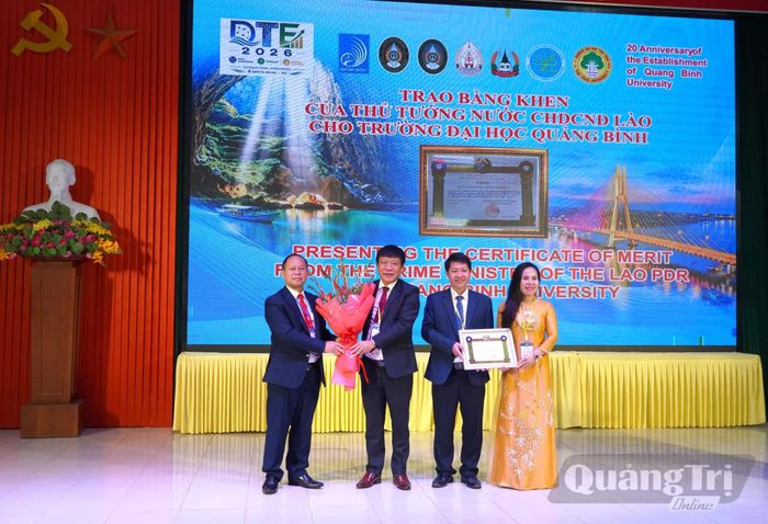 Đại diện Tổng Lãnh sự quán nước CHDCND Lào tại Đà Nẵng trao tặng Bằng khen của Thủ tướng Chính phủ Lào cho tập thể Trường đại học Quảng Bình - Ảnh: H.L