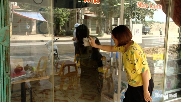 Chị Nguyễn Thị Phượng, thôn Quảng Nguyên (xã Ứng Thiên) lau dọn cửa hàng do khói bụi. Ảnh: Lại Tấn