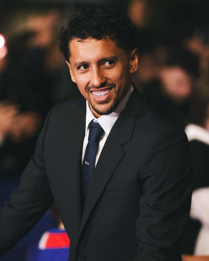 Ngày 21/10, đối đầu với Barcelona tại Champions League, các cầu thủ PSG thu hút sự chú ý với những bộ suit may đo của Dior. Thiết kế gồm áo khoác và quần âu theo phom dáng cổ điển, phối cùng sơ mi trắng. Một số cầu thủ hoàn thiện trang phục bằng cà vạt, trong khi những người khác chọn phong cách tối giản với hàng cúc sơ mi cài kín đến cổ. Sự kết hợp giữa phom dáng truyền thống và cách phối đồ linh hoạt giúp trang phục giữ được nét thanh lịch mà không tạo cảm giác cứng nhắc. Ảnh: PSG.