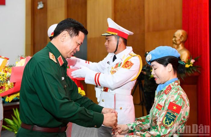 Thượng tướng Nguyễn Trường Thắng trao quyết định cho hai sĩ quan lên đường làm nhiệm vụ. (Ảnh: THẾ ĐẠI)