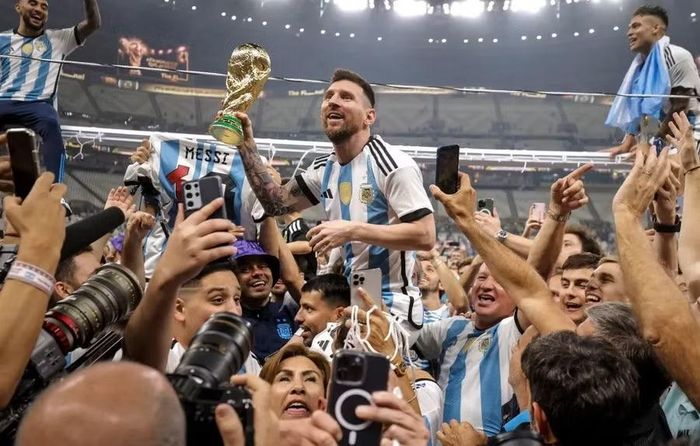 Lionel Messi không hề biết bản thân đang cầm chiếc cúp vàng giả tại lễ đăng quang World Cup 2022. Ảnh: Getty.
