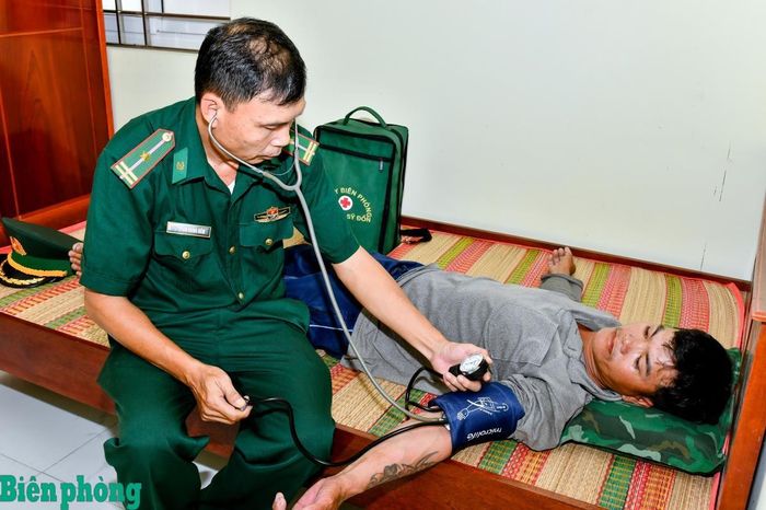 Cán bộ quân y Đồn Biên phòng Trung Bình thăm khám sức khỏe cho thuyền viên. Ảnh: Văn Long