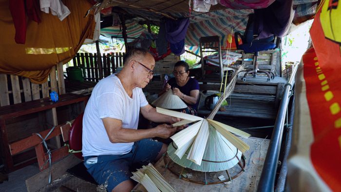  Khi các lớp lá đã được xếp ngay ngắn trên khuôn, chiếc nón cũng dần hiện rõ hình dáng. Tôi tiếp tục chỉnh lại những chỗ lá chưa đều, kiểm tra từng vành nón để chuẩn bị cho bước khâu cố định. 