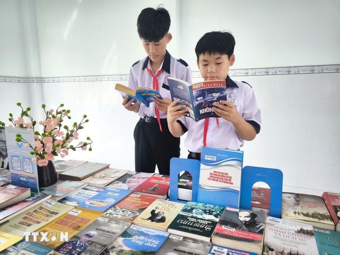 Học sinh tìm hiểu lịch sử tàu không số. (Ảnh: Huỳnh Phúc Hậu/TTXVN)