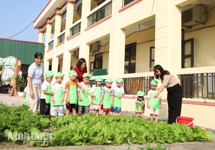 Giáo viên Trường Mầm non Liêm Tuyền hướng dẫn trẻ chăm sóc rau, lồng ghép hoạt động làm vườn vào giáo dục kỹ năng sống.