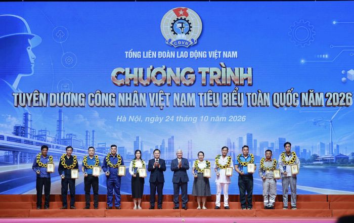  Đồng chí Đỗ Văn Chiến và đồng chí Nguyễn Anh Tuấn cùng 10 công nhân tiêu biểu. Ảnh: HẢI NGUYỄN  