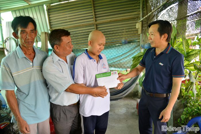 Đồng chí Nguyễn Trọng Tấn, Phó Giám đốc Báo và phát thanh, truyền hình Đồng Tháp, thăm hỏi và trao tiền hỗ trợ của bạn đọc đến em Đỗ Bùi Hoàng Mỹ.