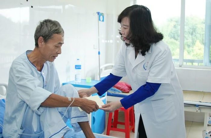Bộ trưởng Y tế Đào Hồng Lan động viên người bệnh đang điều trị tại BVĐK Bắc Kạn. Ảnh: H.T.