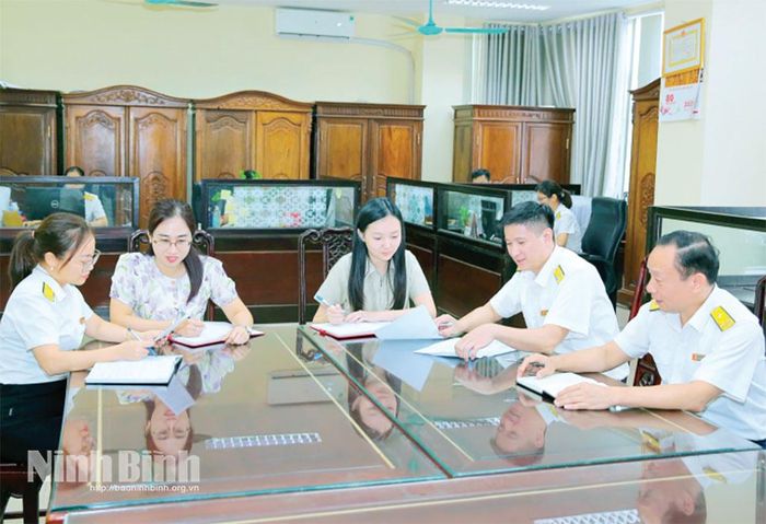 Cán bộ Thuế cơ sở 2 Ninh Bình hướng dẫn doanh nghiệp các thủ tục hành chính khi hoạt động. Ảnh: Anh Tuấn