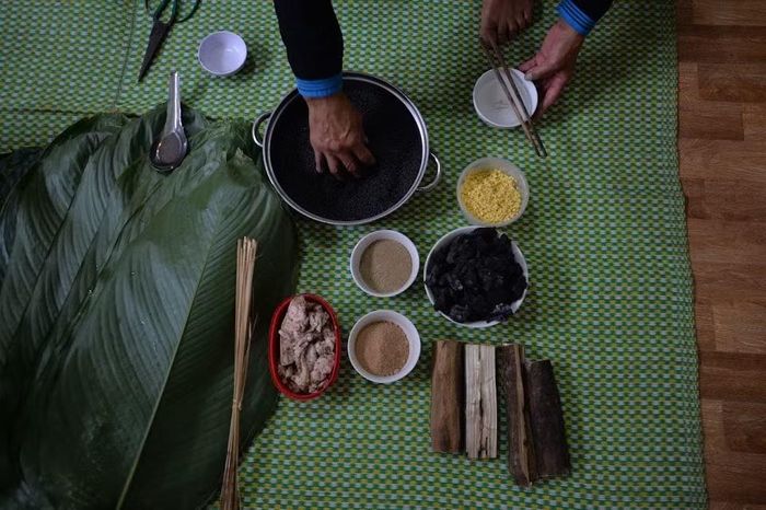 Sau khi gói, bánh được luộc trong khoảng 8-10 tiếng. Khi hoàn thành, chiếc bánh có lớp nếp đen bóng, hình dáng chắc chắn và hương thơm lan tỏa. Ảnh: Phạm Khánh Huy