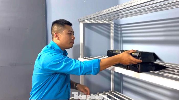 Anh Toàn xếp sản phẩm cà phê bột lên kệ.