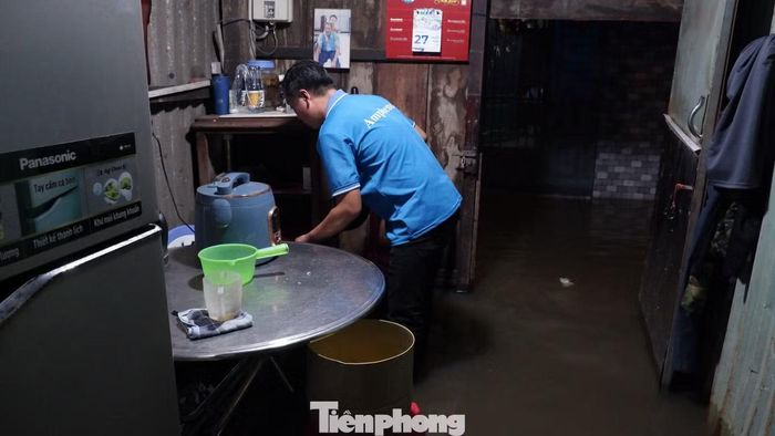 Người dân di dời đồ đạc khi triều cường dâng cao. Ảnh: Hữu Huy