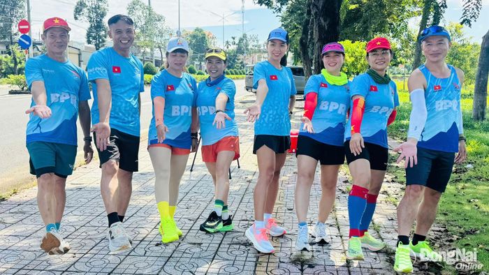 Hoàng Thị Ngọc Hoa (thứ năm từ trái) cùng các thành viên CLB Runner Bình Phước gửi lời mời cộng đồng chạy bộ hội tụ tại Đồng Nai Marathon 2026. Ảnh: Minh Huệ